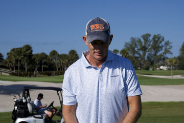 Golfer in a Sarasota polo on a palm-lined course