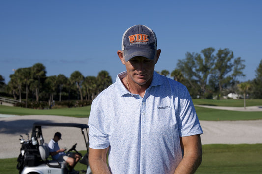 Golfer in a Sarasota polo on a palm-lined course