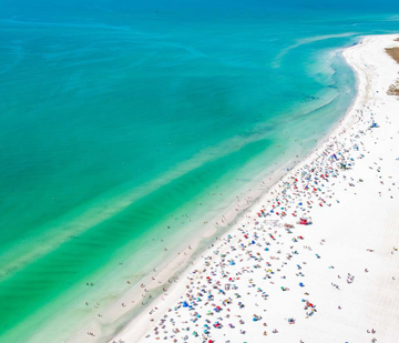 Aerial view of white sand and turquoise Gulf water on Lido Key in Sarasota, Florida