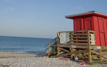 Red lifeguard stand on a white sand Sarasota beach