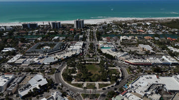 Aerial view of St. Armands Circle with Lido Key's hotels and Gulf beach beyond