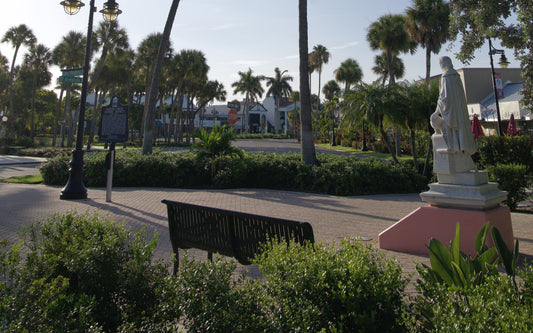 Palm trees and a classical statue in the park at the center of St. Armands Circle