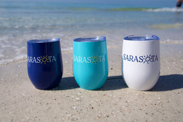 Navy, aqua and white Sarasota wine tumblers on the sand