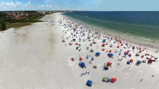 Aerial view of a busy Siesta Key Beach with umbrellas along the Gulf